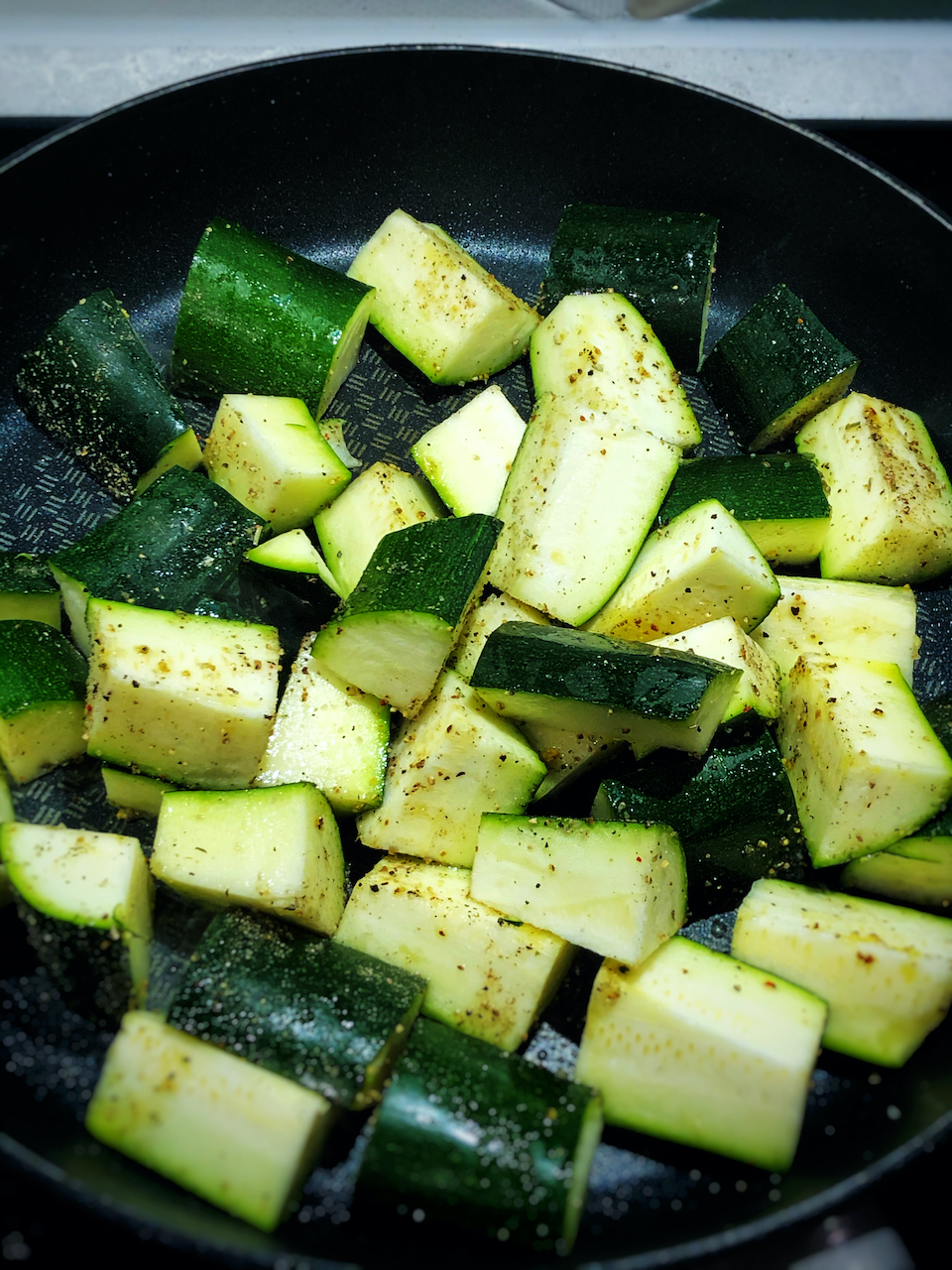 frying the zucchini in a pan