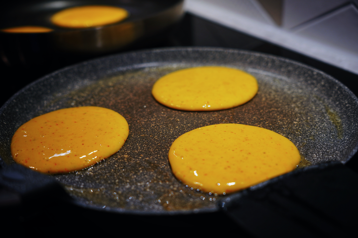 Banana and saffron pancakes in the pan