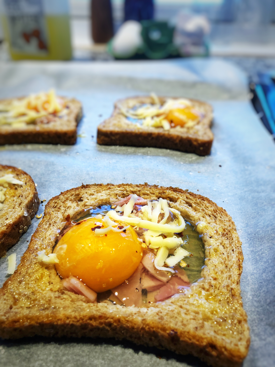 Crack one egg on top of the ham (in the hole in the bread)