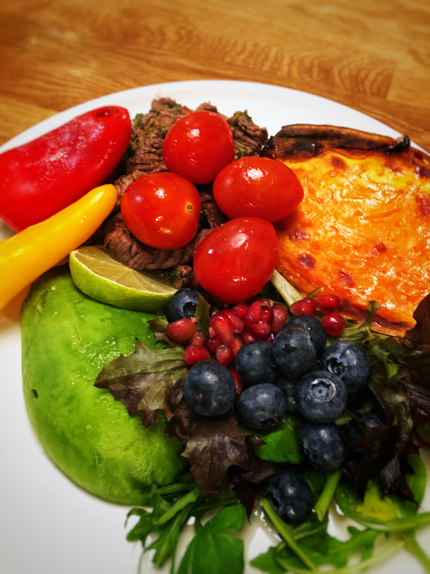 Cilantro fried beef slices with baked sweet potato, blueberries and pomegranate